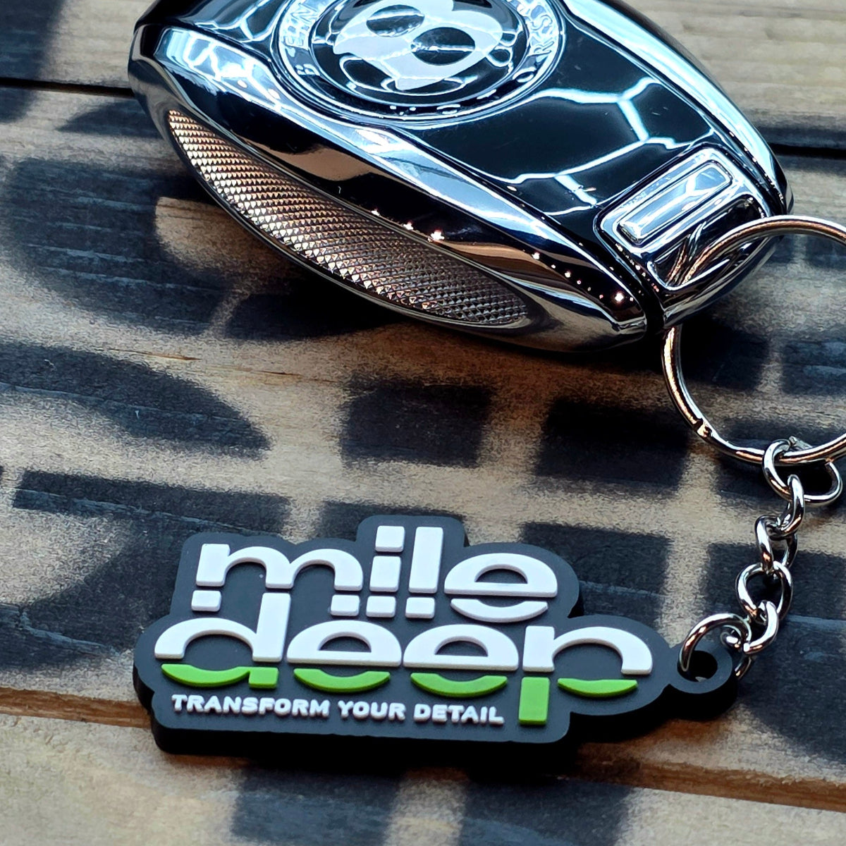 PVC keychain with a brand logo on a wooden surface